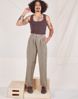 Jesse is wearing Heritage Trousers in Khaki Grey and espresso brown Tank Top