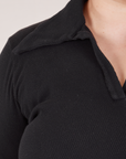 Front shoulder close up of Long Sleeve Fisherman Polo in Basic Black worn by Ashley