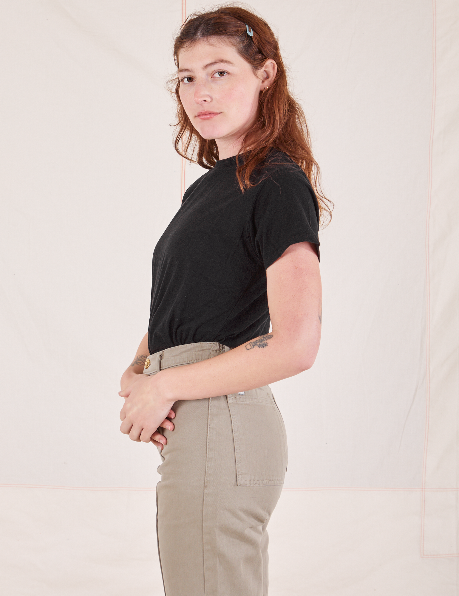 Side view of Organic Vintage Tee in Basic Black and khaki grey Western Pants worn by Alex