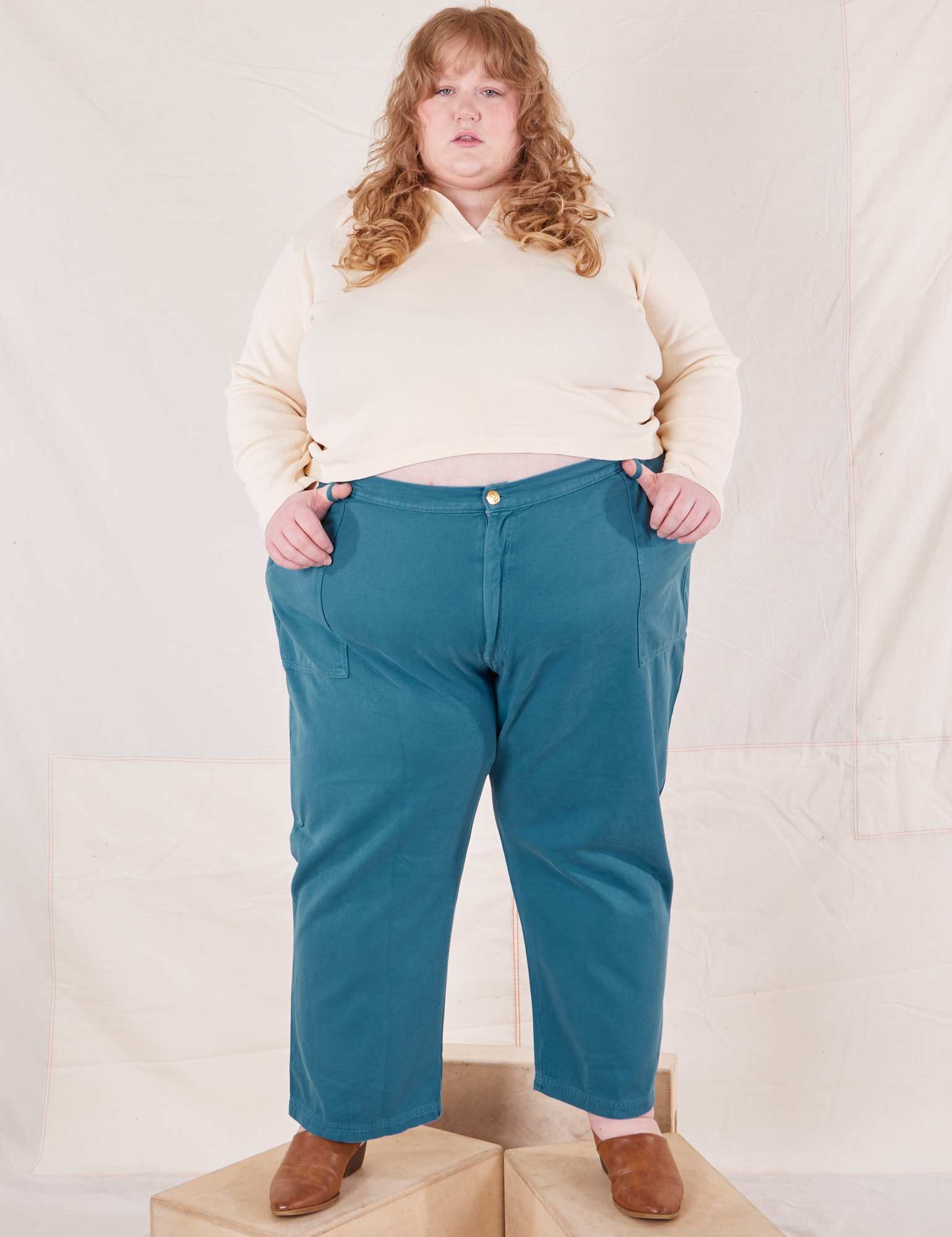 Catie is 5&#39;11&quot; and wearing 5XL Organic Work Pants in Marine Blue paired with vintage off-white Long Sleeve Fisherman Polo