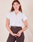 Alex is wearing Pantry Button-Up in Vintage Tee Off-White tucked into espresso brown Western Pants