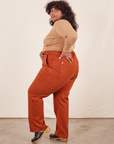Side view of Work Pants in Burnt Terracotta and tan Wrap Top on Morgan