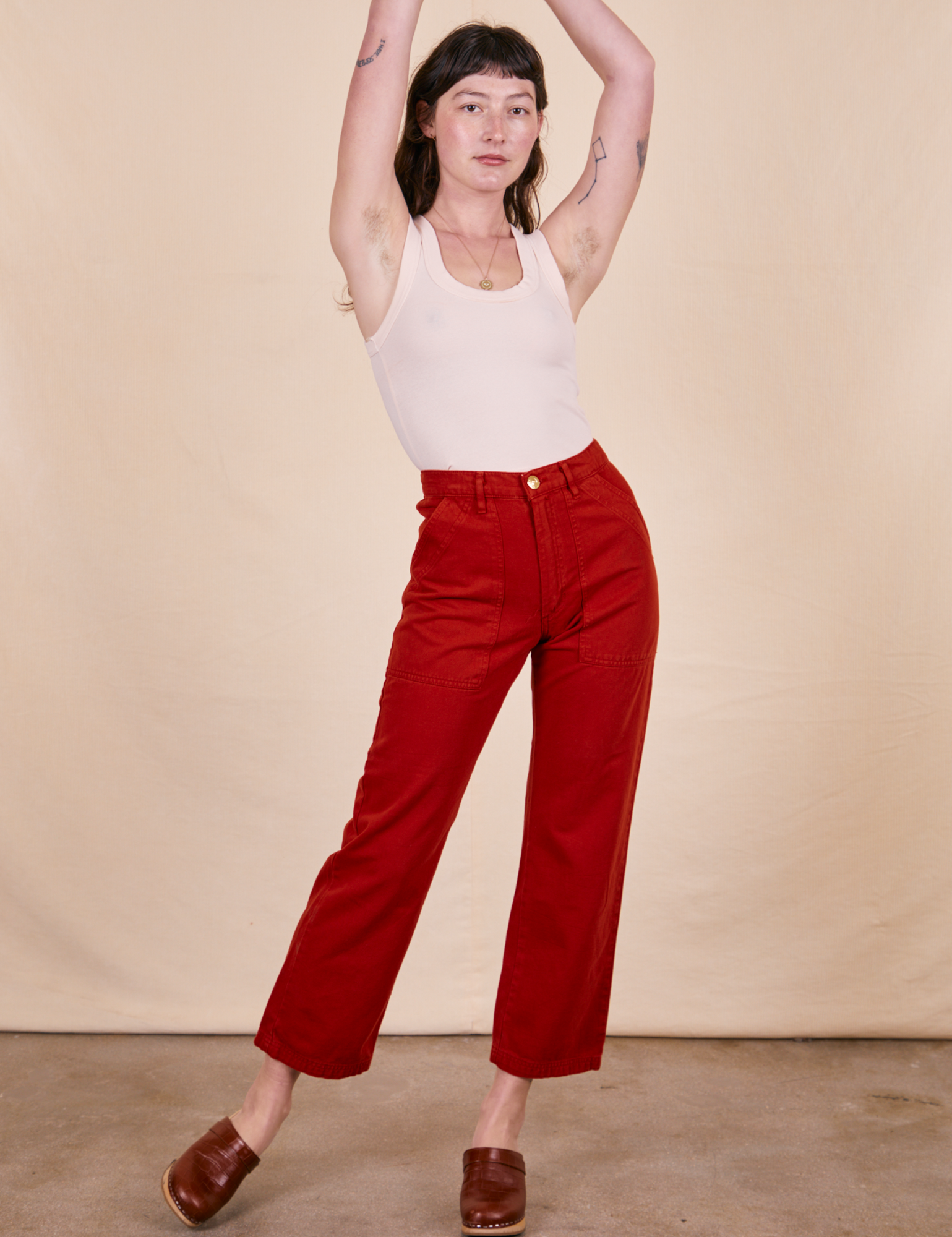 Alex is 5&#39;8&quot; and wearing XS Work Pants in Paprika paired with vintage off-white Tank Top