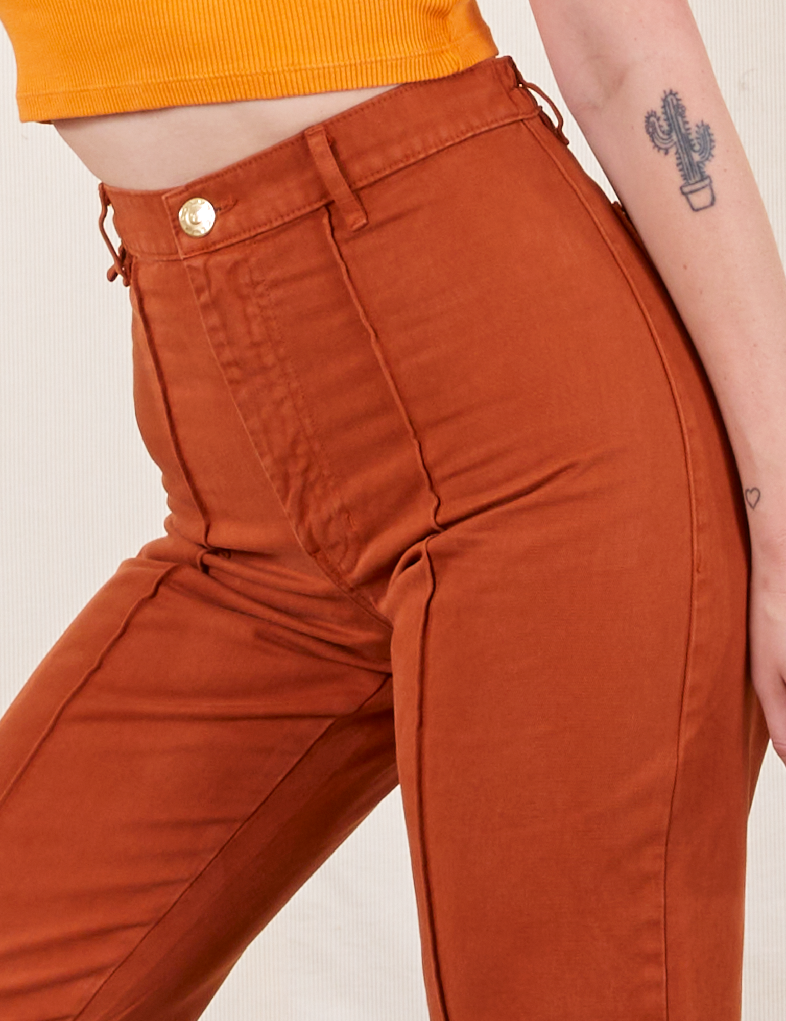Close up of Western Pants in Burnt Terracotta on Alex
