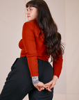 Angled back view of Essential Turtleneck in Paprika worn by Sydney