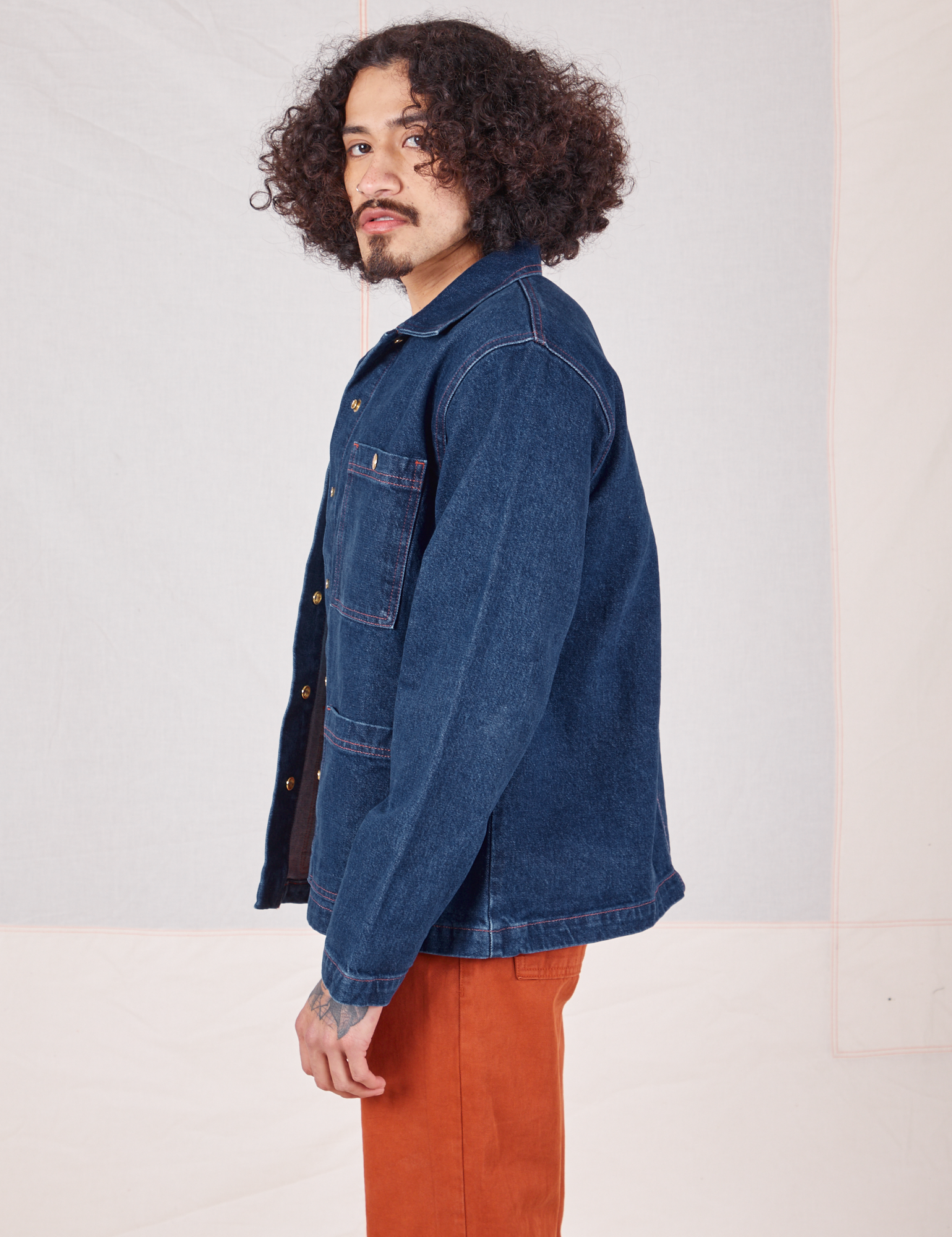 Side view of Indigo Denim Work Jacket in Dark Wash worn by Jesse