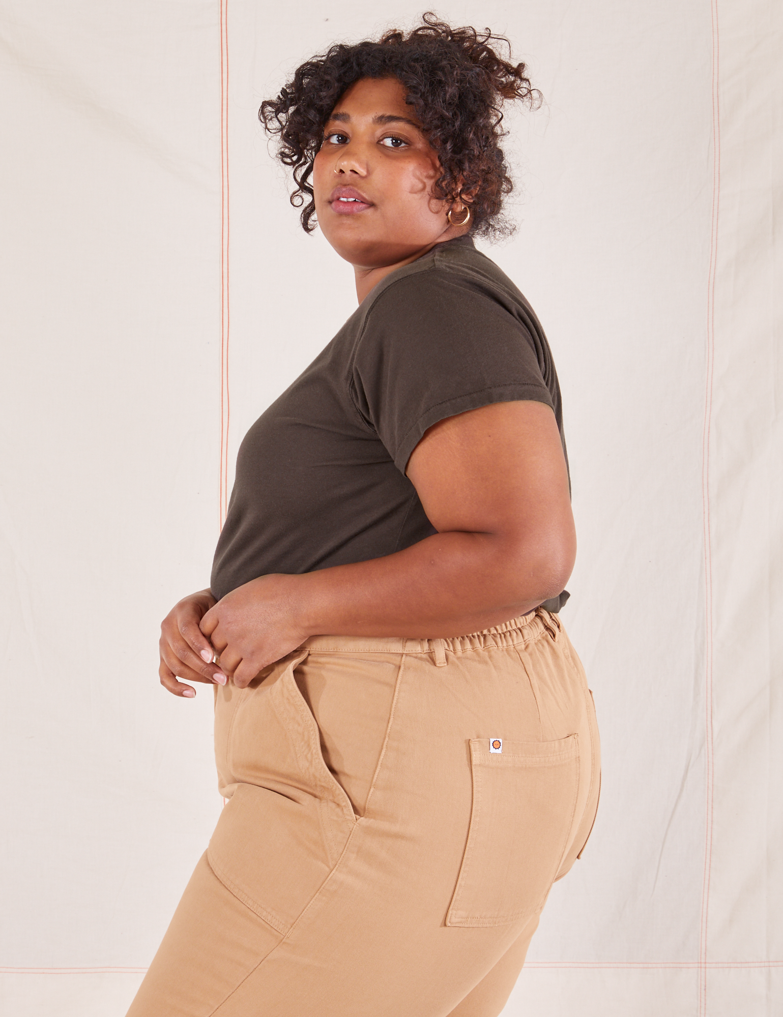 Side view of Organic Vintage Tee in Espresso Brown and tan Work Pants worn by Morgan