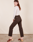 Side view of Work Pants in Espresso Brown and Long Sleeve V-Neck Tee in  vintage tee off-white on Alex