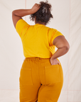 Back view of Organic Vintage Tee in Sunshine Yellow and spicy mustard Western Pants worn by Morgan