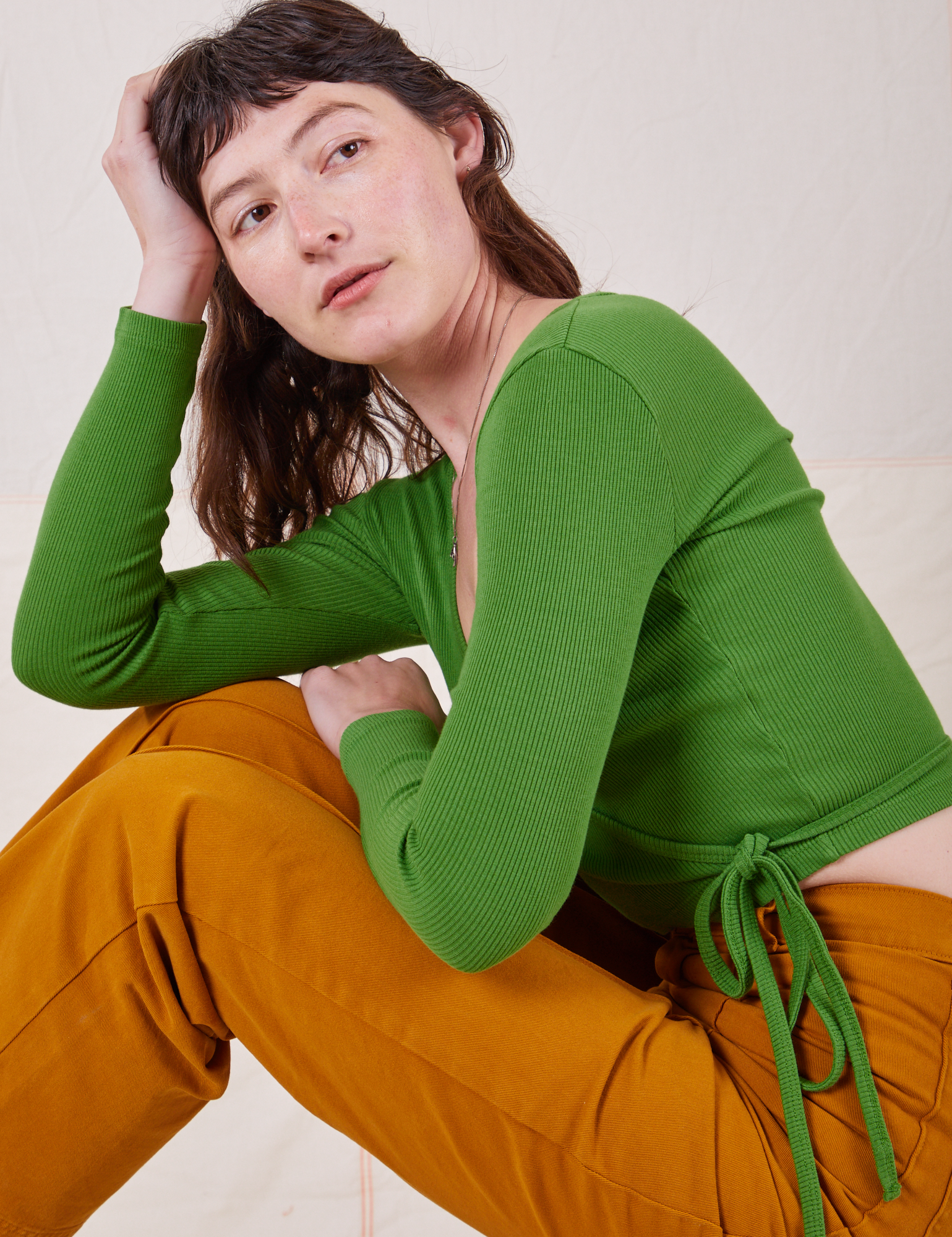 Alex is wearing Wrap Top in Bright Olive and spicy mustard Western Pants