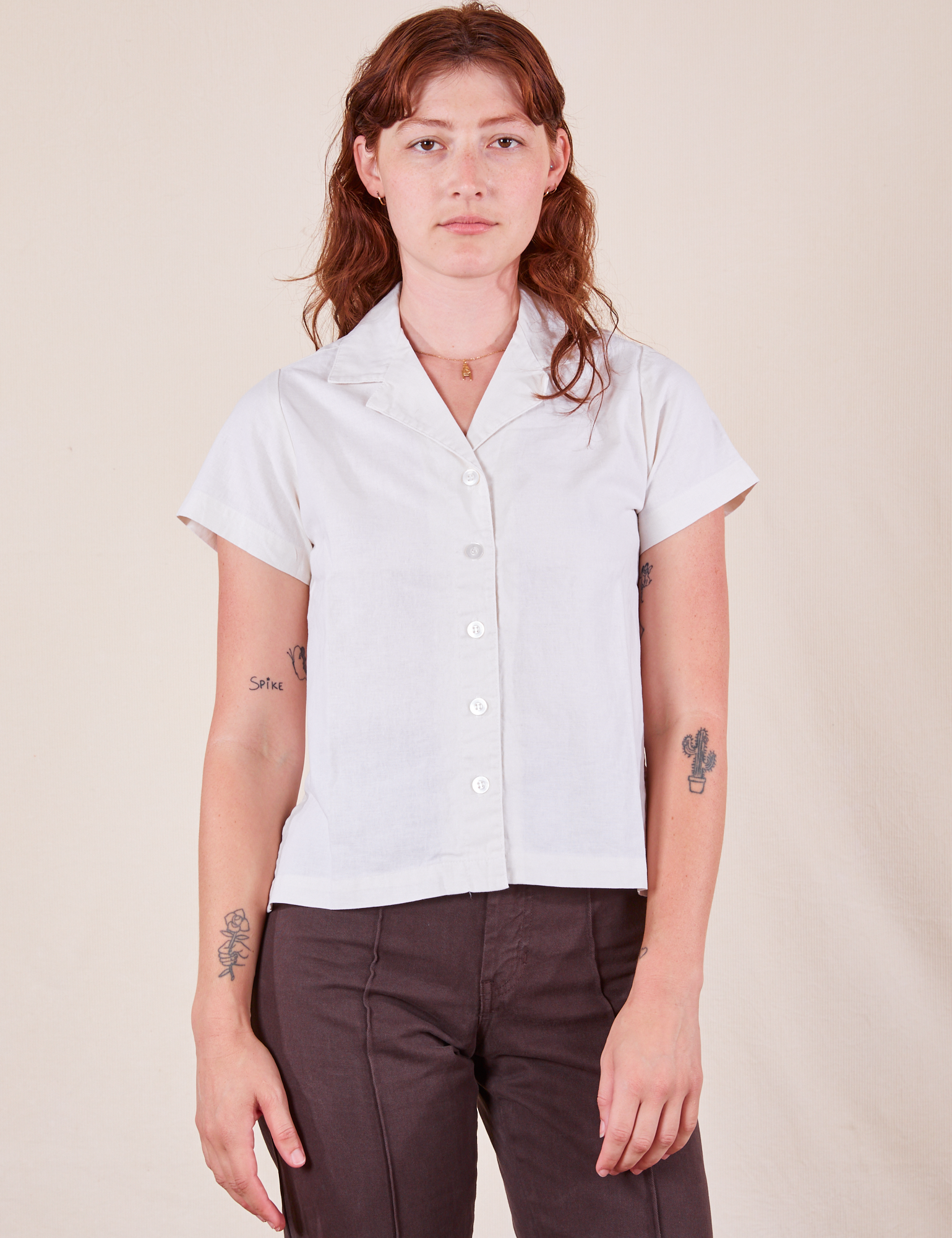Alex is wearing Pantry Button-Up in Vintage Tee Off-White and espresso brown Western Pants