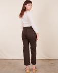 Back view of Work Pants in Espresso Brown and Long Sleeve V-Neck Tee in vintage tee off-white on Alex