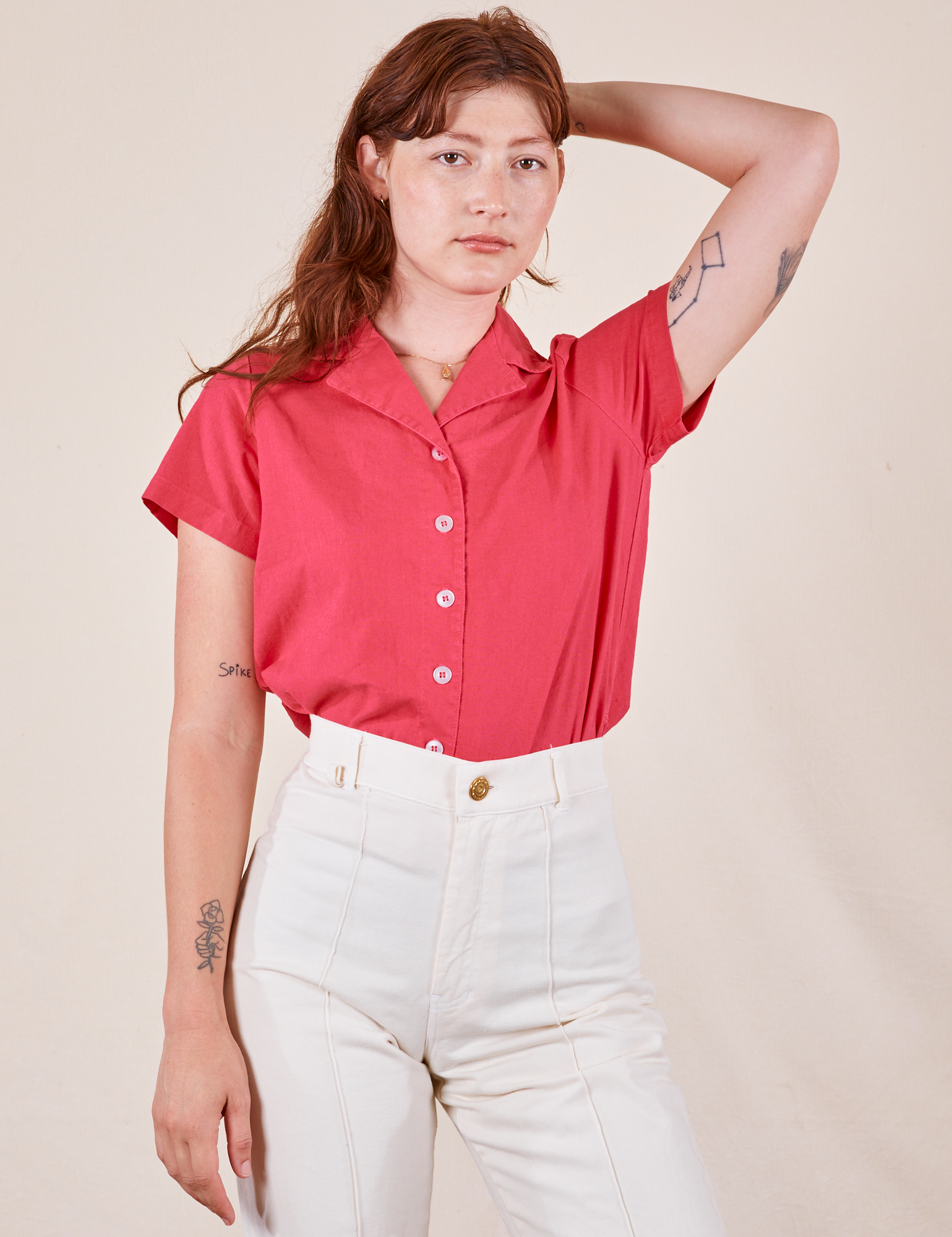 Alex is wearing Pantry Button-Up in Hot Pink tucked into vintage off-white Western Pants