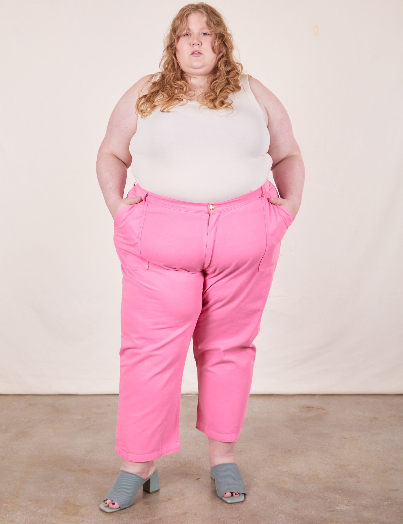 Catie is 5&#39;11&quot; and wearing size 5XL Work Pants in Bubblegum Pink paired with Tank Top in vintage tee off-white