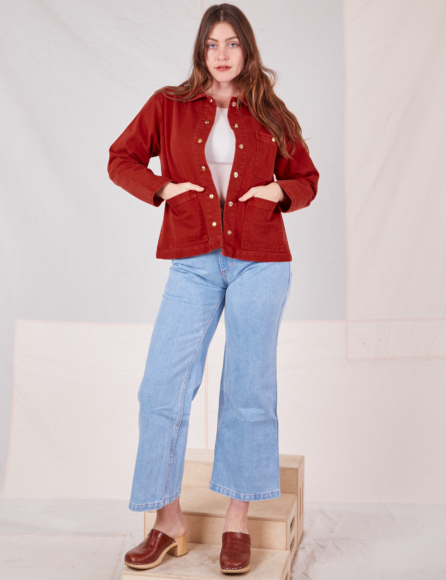 Allison is 5&#39;10&quot; and wearing XS Denim Work Jacket in Paprika paired with light wash Sailor Jeans