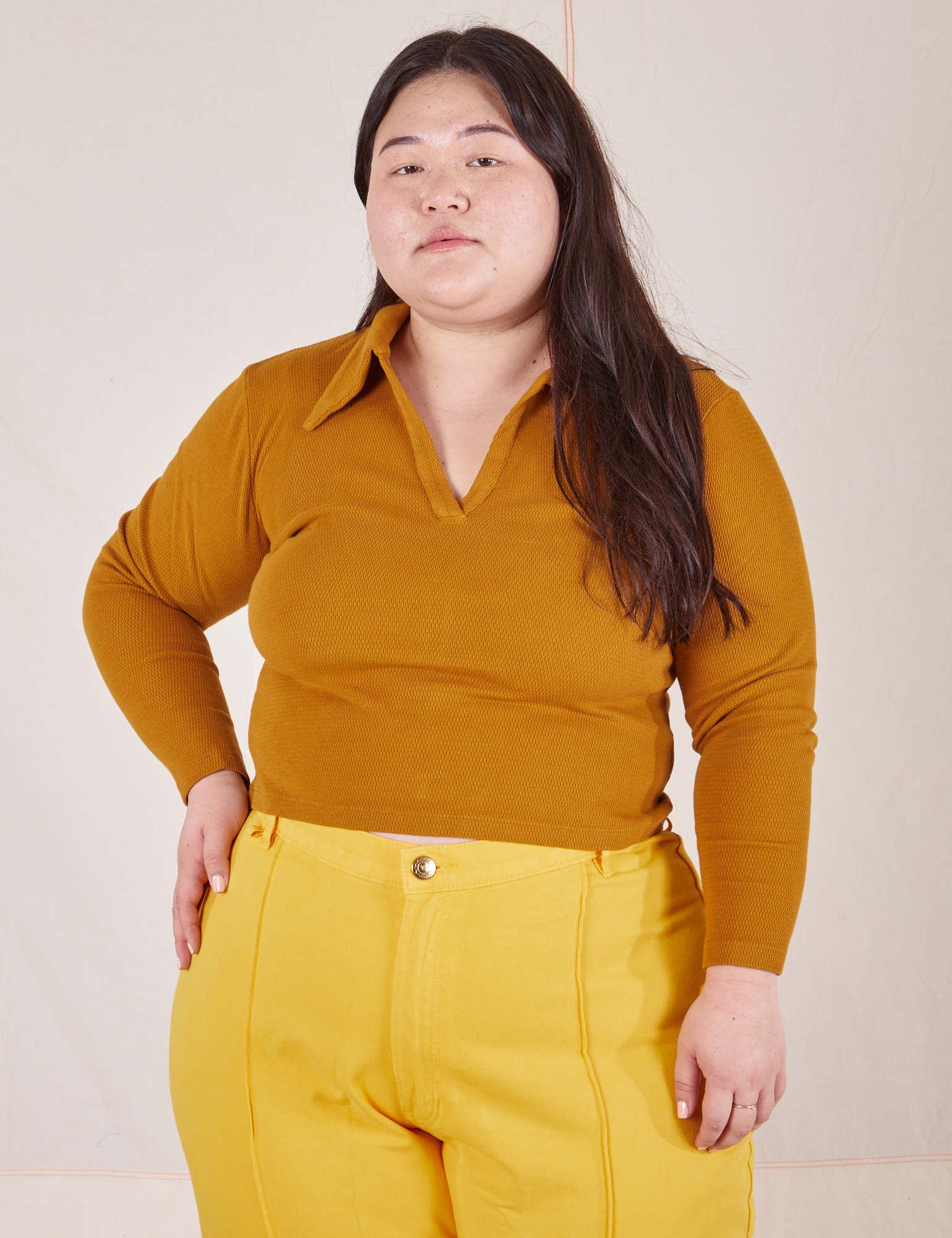 Ashley is wearing size L Long Sleeve Fisherman Polo in Spicy Mustard