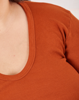 Long Sleeve V-Neck Tee in Burnt Terracotta neckline close up on Sarita