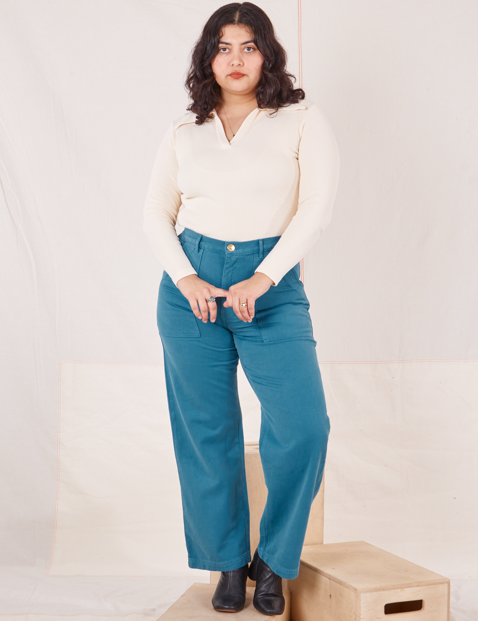 Melanie is 5&#39;6&quot; and wearing M Organic Work Pants in Marine Blue paired with vintage off-white Long Sleeve Fisherman Polo