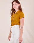 Side view of Pantry Button-Up in Spicy Mustard and vintage tee off-white Western Pants worn by Alex