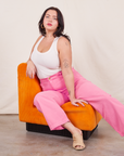 Work Pants in Bubblegum Pink on Faye wearing vintage off-white Tank Top sitting in orange chair