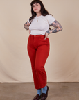 Sydney is wearing Work Pants in Paprika and Baby Tee in vintage tee off-white