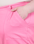 Work Pants in Bubblegum Pink front pocket close up. Worn by Catie with hand in pocket.