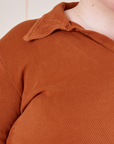 Front close up of Long Sleeve Fisherman Polo in Burnt Terracotta worn by Catie