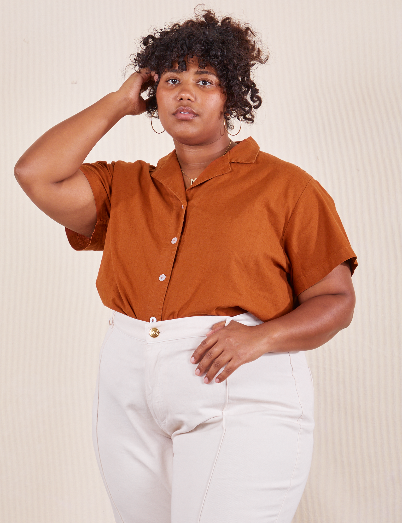 Morgan is wearing Pantry Button-Up in Burnt Terracotta tucked into vintage tee off-white Western Pants