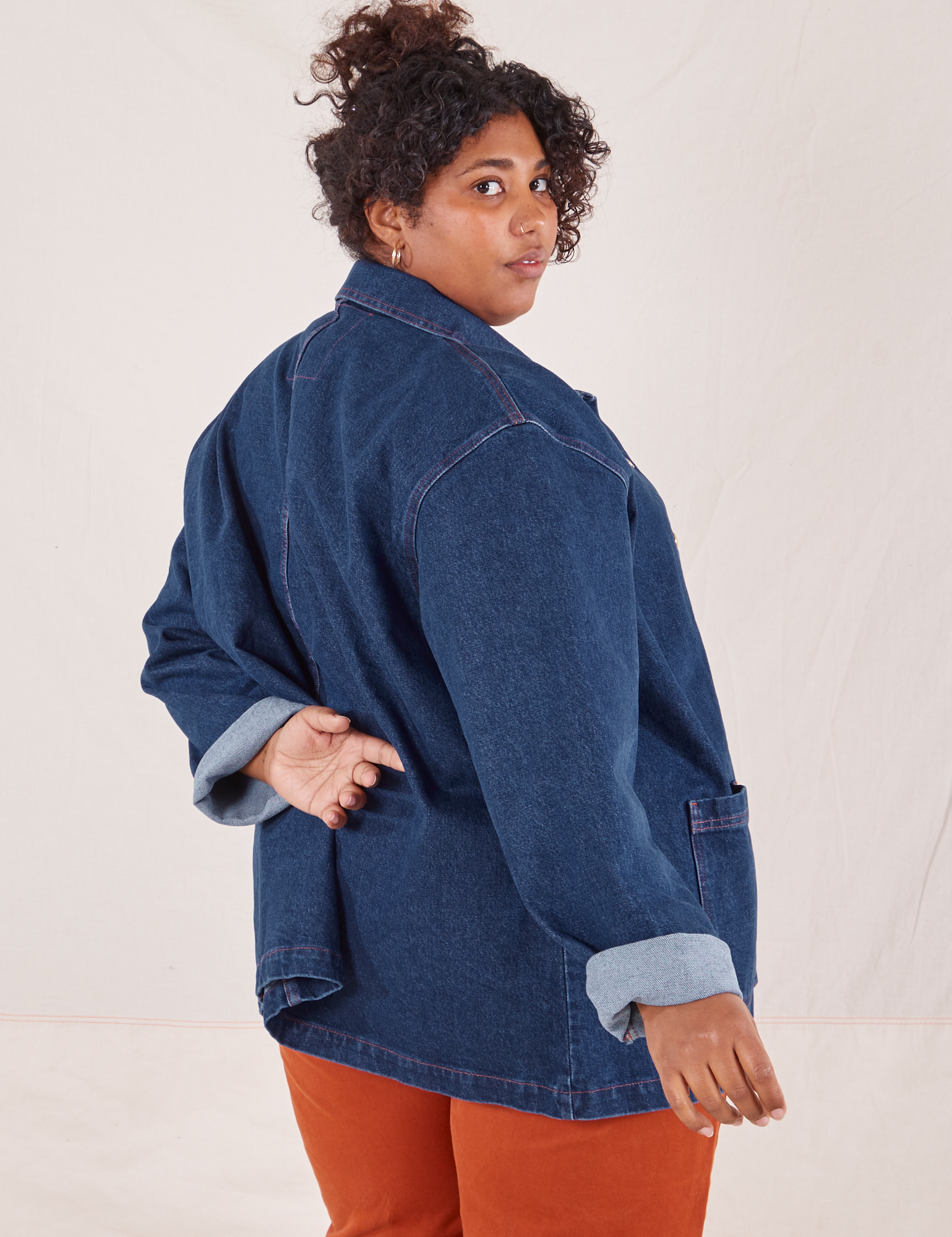 Angled back view of Indigo Denim Work Jacket in Dark Wash worn by Morgan