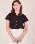 Alex is wearing Pantry Button-Up in Basic Black tucked into vintage tee off-white Western Pants