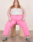 Work Pants in Bubblegum Pink on Catie wearing Tank Top in vintage tee off-white sitting on wooden crate