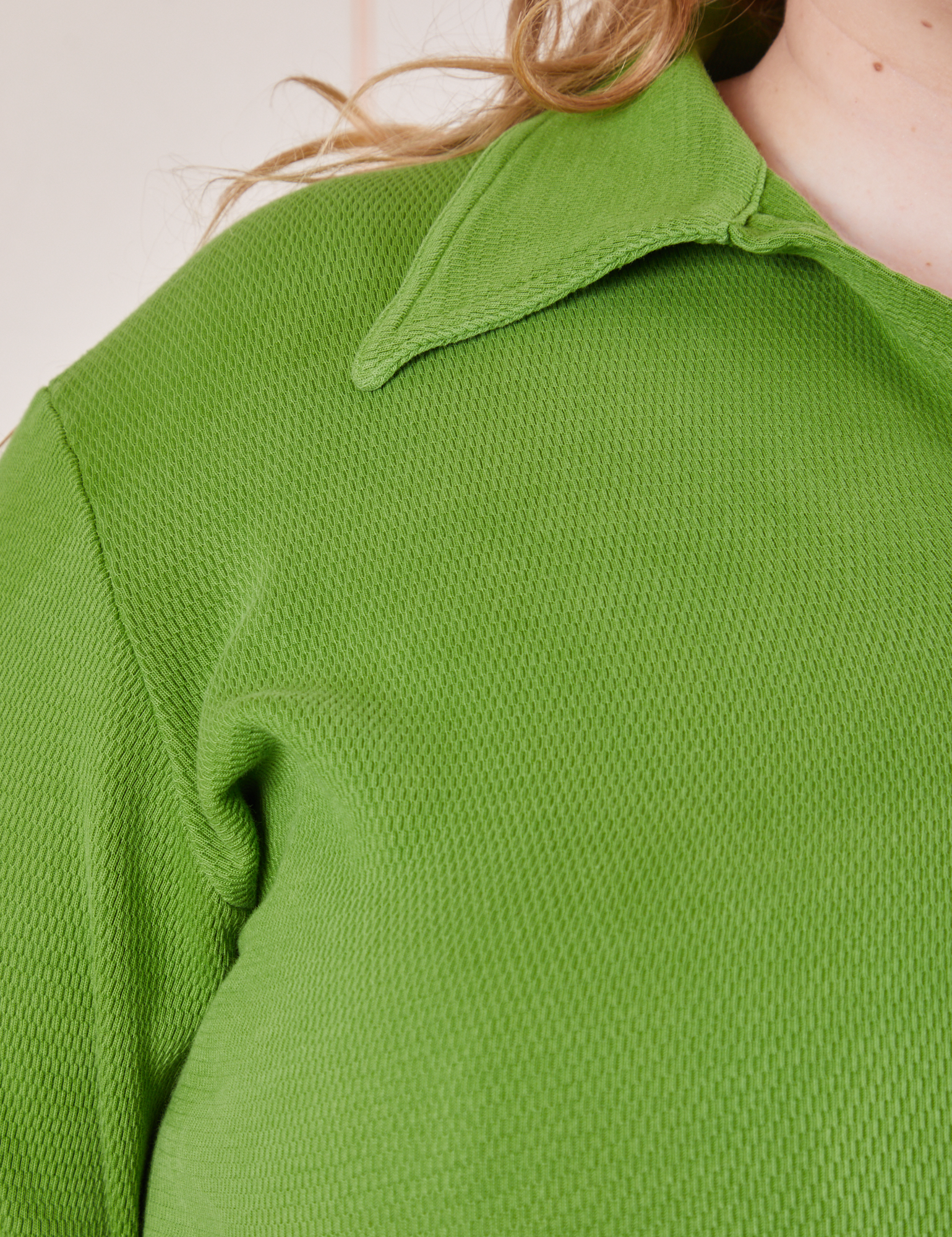 Front close up of Long Sleeve Fisherman Polo in Bright Olive worn by Catie