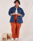 Morgan is wearing Indigo Denim Work Jacket in Dark Wash, vintage off-white Baby Tee, and burnt terracotta Western Pants