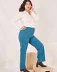 Side view of Organic Work Pants in Marine Blue and vintage off-white Long Sleeve Fisherman Polo worn by Melanie
