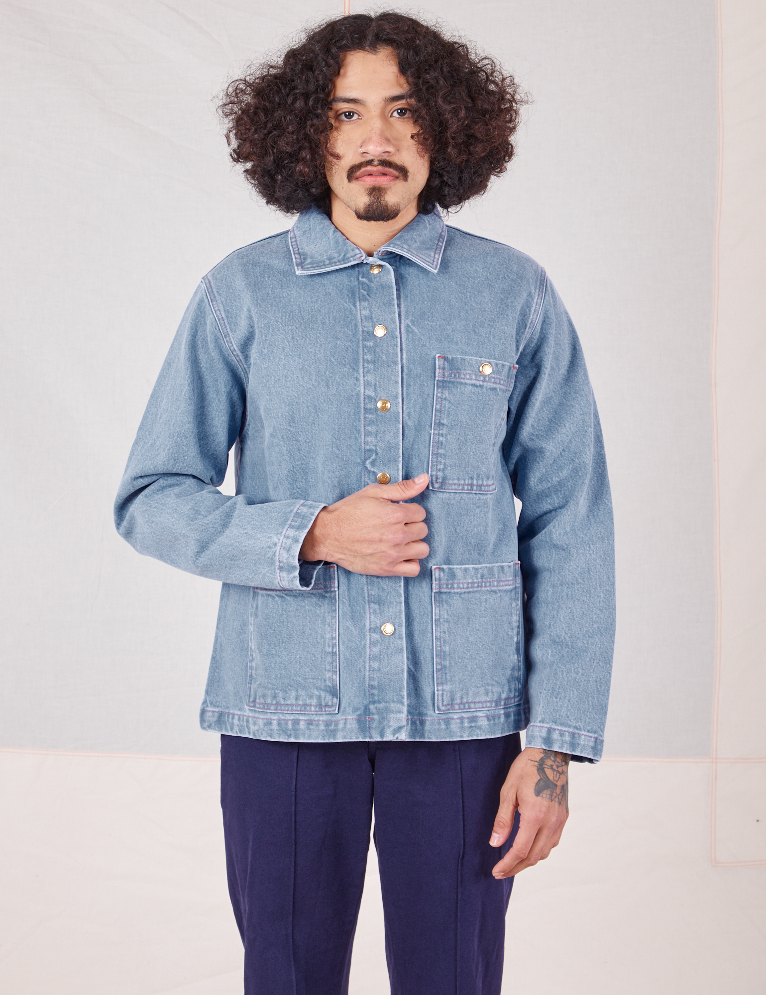 Jesse is wearing Indigo Denim Work Jacket in Light Wash and navy Western Pants