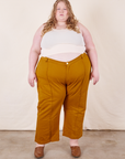 Catie is 5'11" and wearing 5XL Western Pants in Spicy Mustard paired with vintage off-white Tank Top