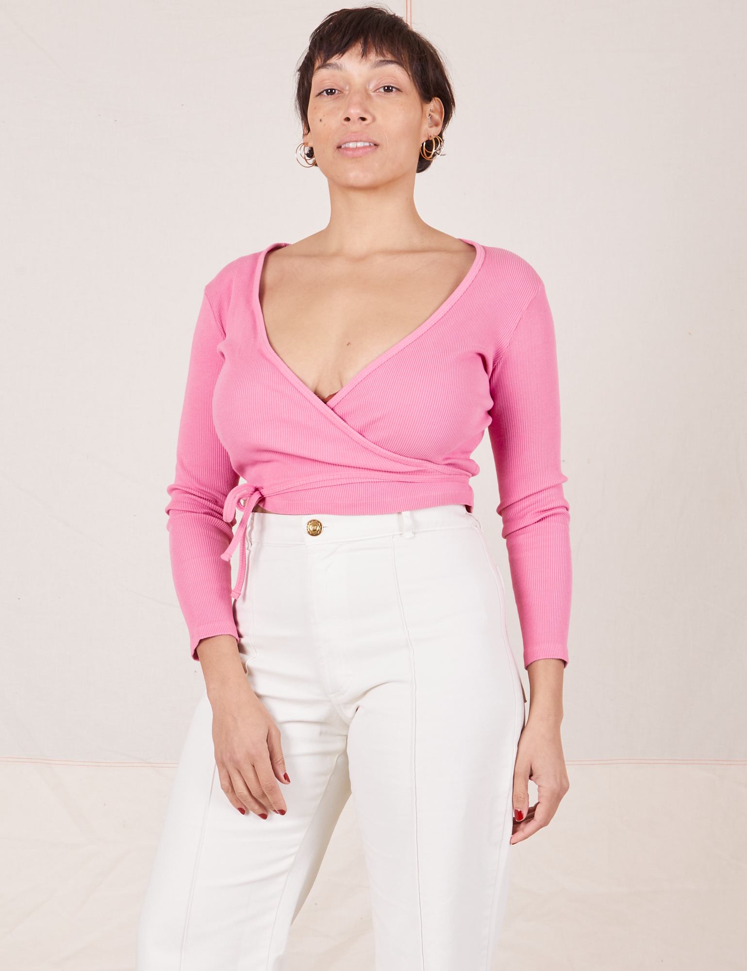 Tiara is wearing size 2 Wrap Top in Bubblegum Pink paired with vintage tee off-white Western Pants