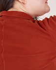 Back shoulder close up of Long Sleeve Fisherman Polo in Paprika worn by Ashley