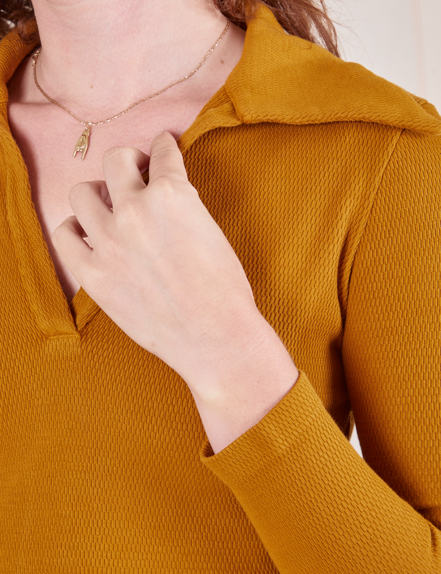 Front close up of Long Sleeve Fisherman Polo in Spicy Mustard worn by Alex