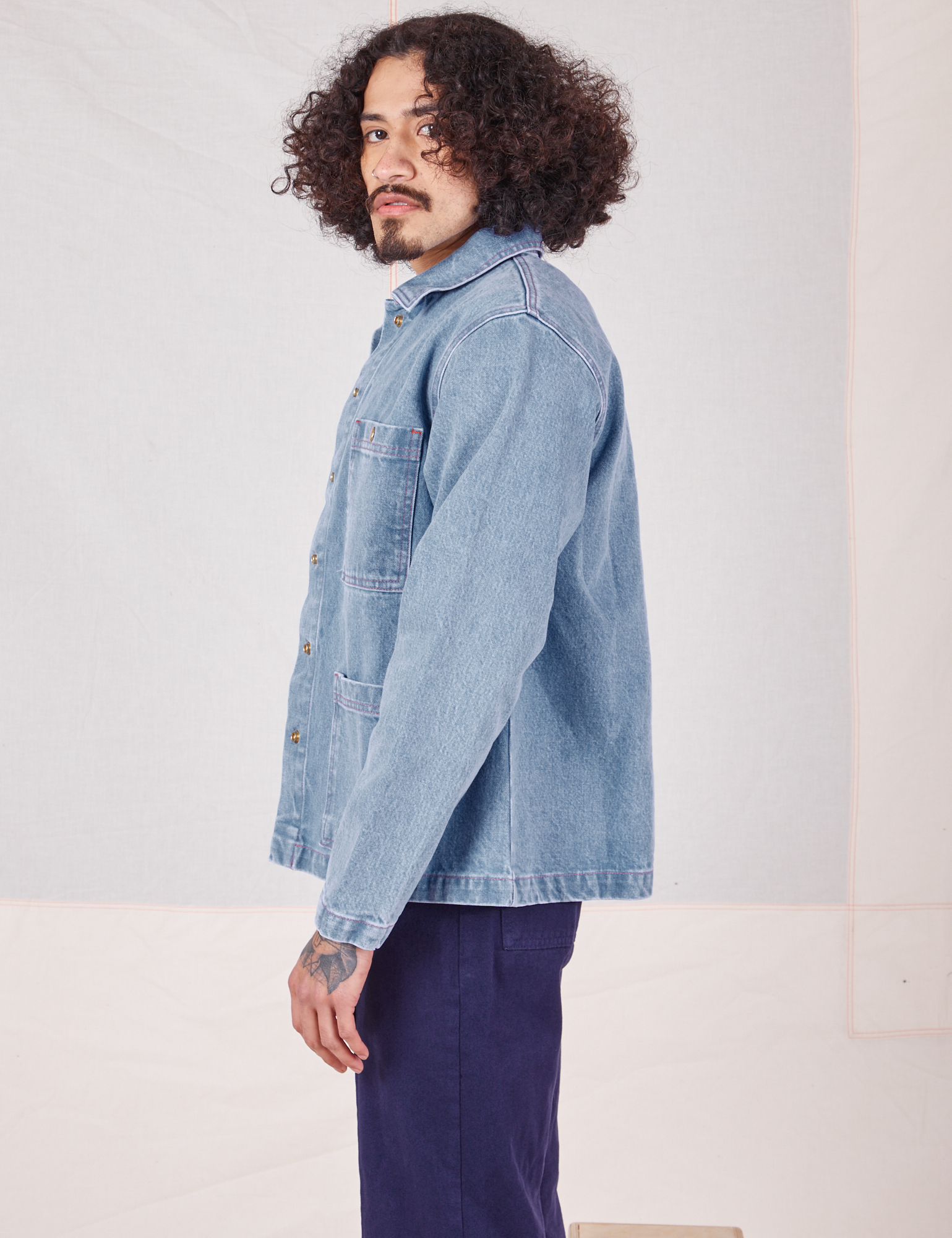 Side view of Indigo Denim Work Jacket in Light Wash worn by Jesse