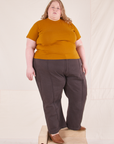 Catie is wearing 3XL Organic Vintage Tee in Spicy Mustard paired with espresso brown Western Pants