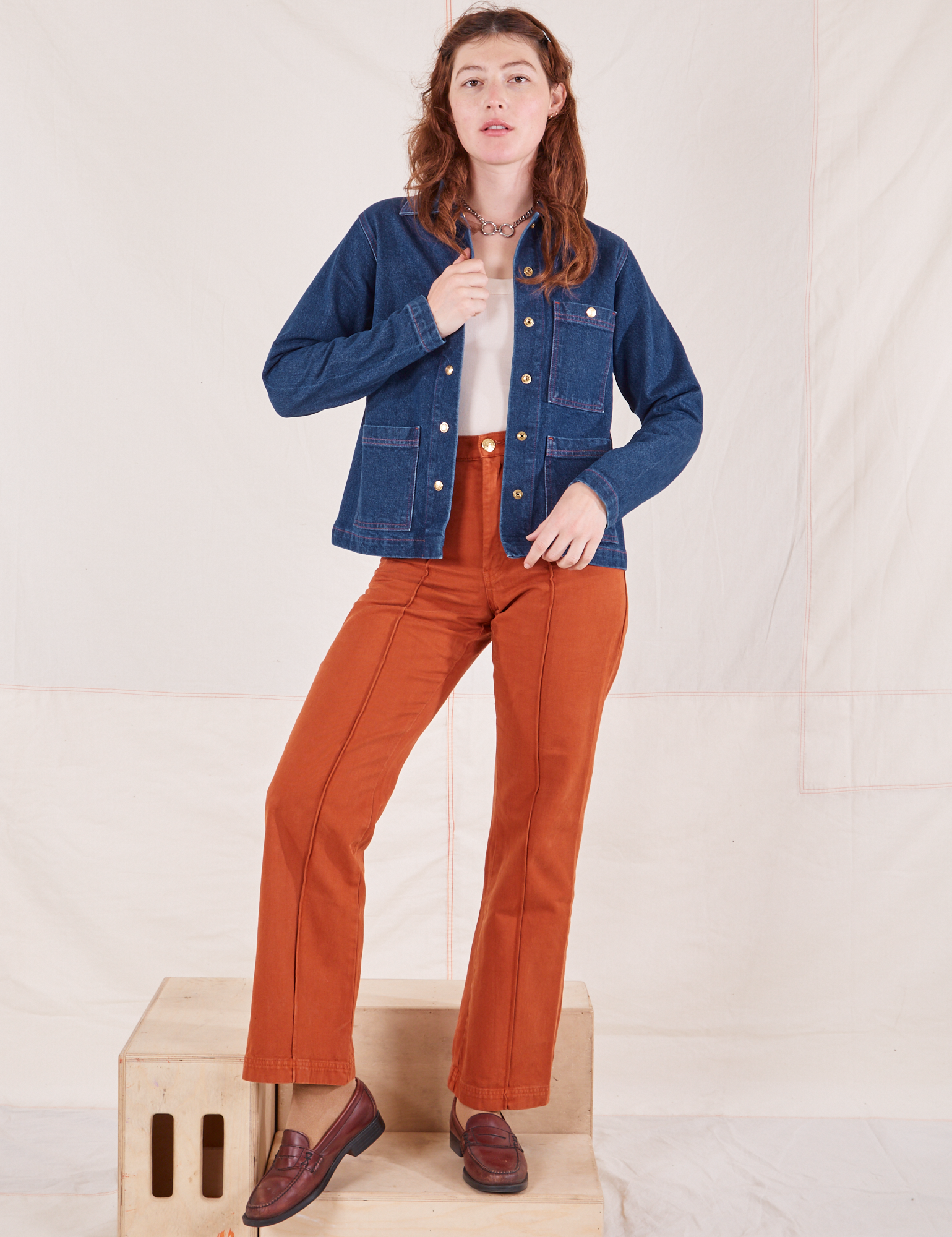 Alex is 5'8" and wearing XXS Indigo Denim Work Jacket in Dark Wash paired with burnt terracotta Western Pants