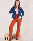 Alex is 5'8" and wearing XXS Indigo Denim Work Jacket in Dark Wash paired with burnt terracotta Western Pants