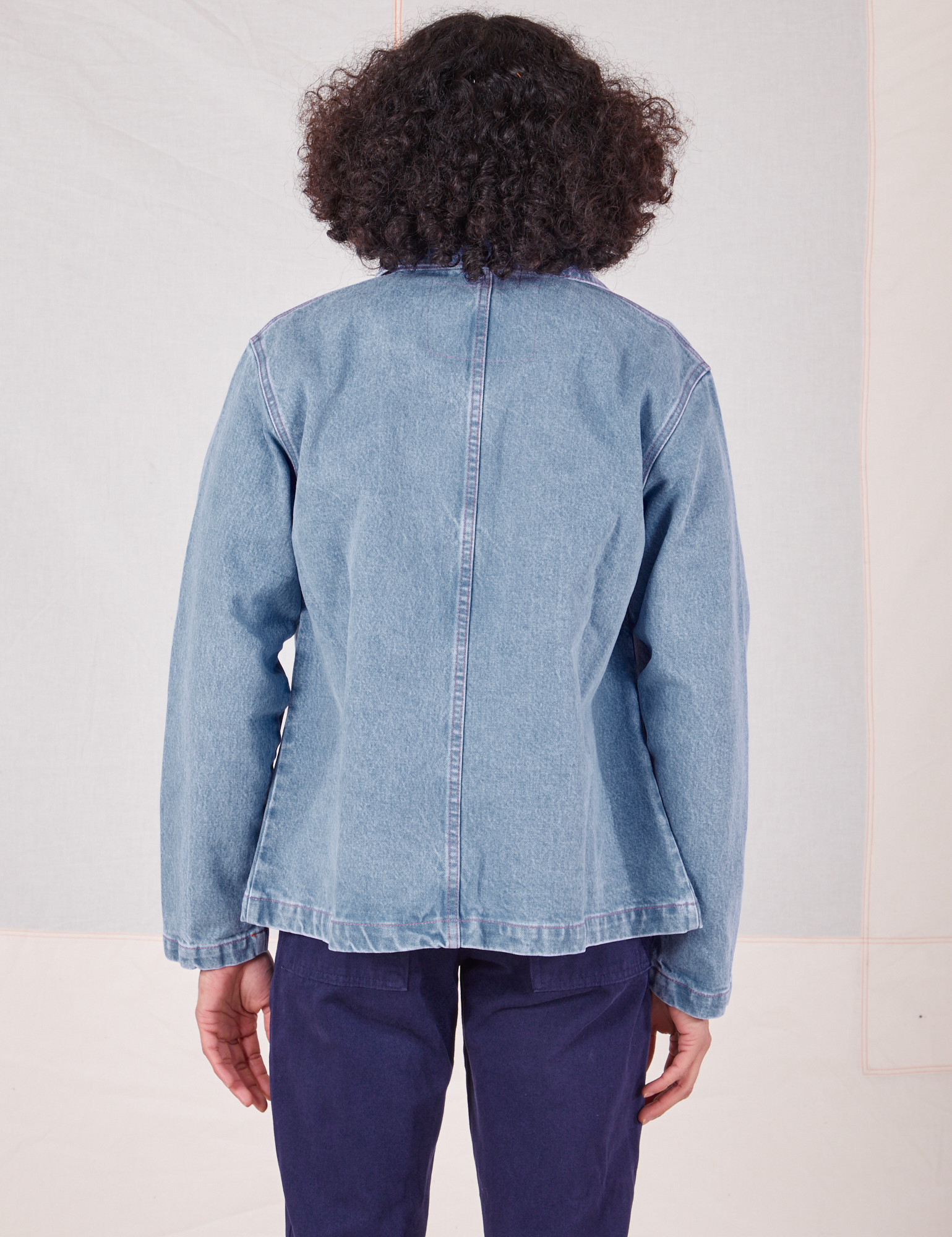 Back view of Indigo Denim Work Jacket in Light Wash worn by Jesse
