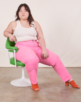 Work Pants in Bubblegum Pink on Ashley wearing Tank Top in vintage tee off-white sitting in green chair