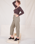 Side view of Heritage Trousers in Khaki Grey and espresso brown Long Sleeve V-Neck Tee worn by Allison