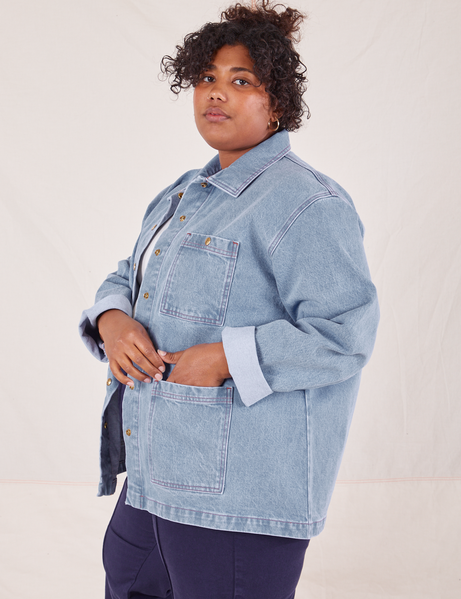Angled view of Indigo Denim Work Jacket in Light Wash worn by Morgan.
