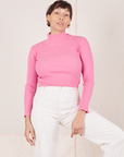 Tiara is wearing XS Essential Turtleneck in Bubblegum Pink paired with vintage tee off-white Western Pants