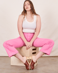 Western Pants in Bubblegum Pink on Allison wearing Tank Top in vintage tee off-white sitting on wooden crate