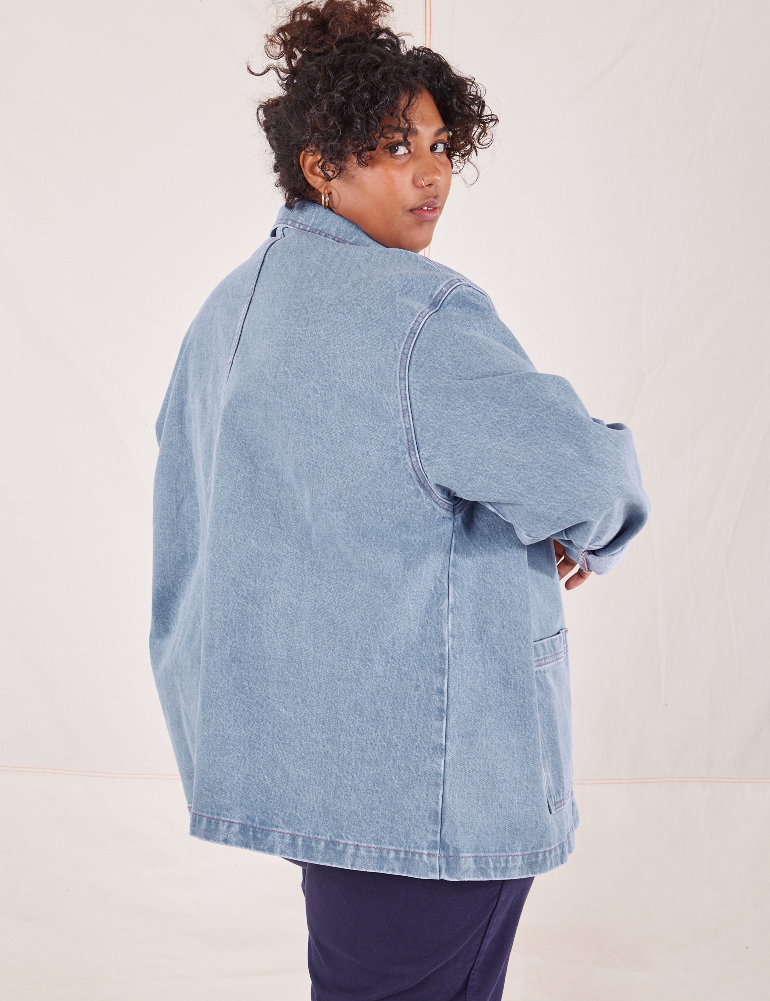 Angled back view of Indigo Denim Work Jacket in Light Wash worn by Morgan
